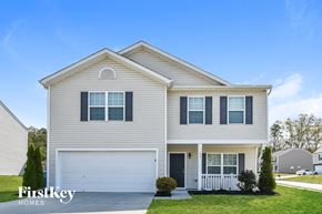 Whitsett house for rent - A two-story house with a garage and a front porch.