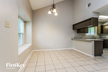 Humble house for rent - A kitchen area with a sink and a window.