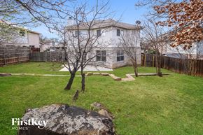 Corinth house for rent - A large rock sits in the middle of a grassy yard.