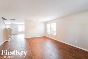 Grand Prairie house for rent - A room with wooden flooring and a chandelier.