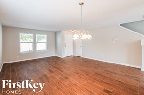 Grand Prairie house for rent - A room with wooden flooring and a chandelier hanging from the ceiling.