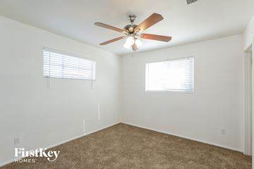 Phoenix house for rent - a living room with a ceiling fan and a carpet