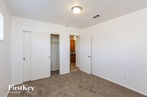 Phoenix house for rent - a bedroom with white walls and carpet and a door to a bathroom