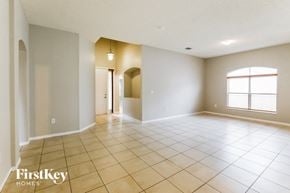 Homestead house for rent - an empty living room with tiled floors and a large window