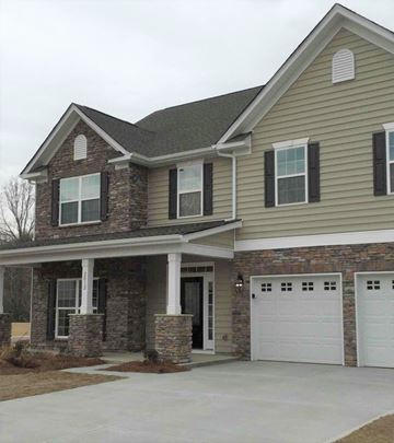 Davidson house for rent - a house with a white garage door in front of it