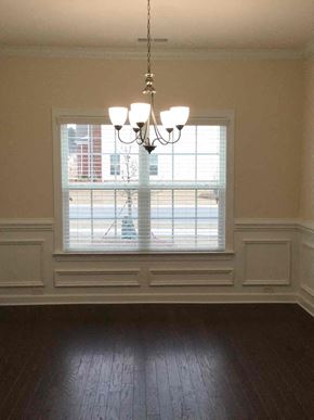 Davidson house for rent - an empty living room with a window and a chandelier