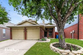 Lewisville house for rent - a home with a tree in the front yard and a driveway