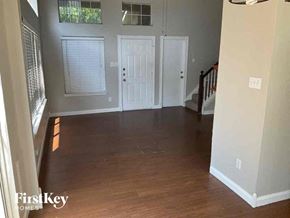 Lewisville house for rent - an empty living room with a hard wood floor