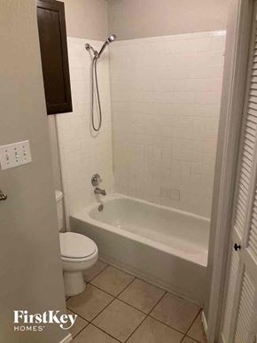 Lewisville house for rent - a small bathroom with a shower and a toilet