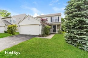 Grove City house for rent - A house with a white garage door is for sale by FirstKey Homes.