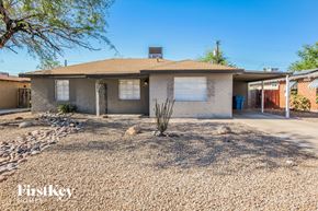 Phoenix house for rent - A house with a brown roof and a gravel driveway in front of it.