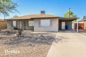 Phoenix house for rent - A house with a brown roof and a blue trash can in front.