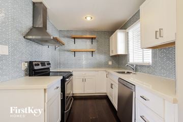 Phoenix house for rent - A kitchen with a stove top oven and a dishwasher.