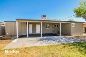 Phoenix house for rent - A house with a grey exterior and a brown roof is shown.