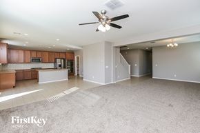 San Tan Valley house for rent - A spacious living room with a kitchen area in the background.