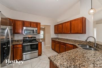 Cape Coral house for rent - a kitchen with granite counter tops and stainless steel appliances