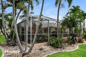 Cape Coral house for rent - a house with palm trees in front of it