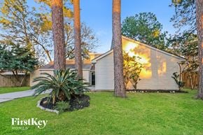 Humble house for rent - a white house with a yard and trees