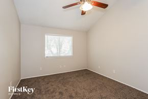 Humble house for rent - a bedroom with carpet and a ceiling fan