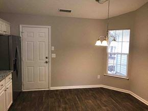 Kannapolis house for rent - A kitchen with a white door and a window with blinds.