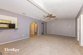 Garland house for rent - A spacious room with a ceiling fan and a bar area.