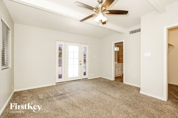 Phoenix house for rent - a living room with carpet and a ceiling fan