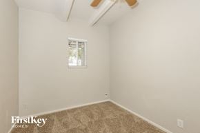 Phoenix house for rent - a bedroom with white walls and carpet and a window