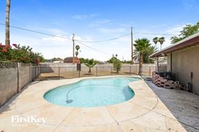 Phoenix house for rent - a small pool in the backyard of a house with a fence