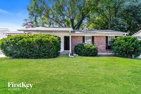Florissant house for rent - A house with a lawn and trees in the background.
