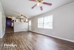 Decatur house for rent - A room with a ceiling fan and wooden flooring.