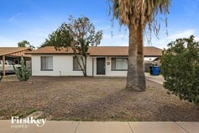 Phoenix house for rent - a small white house with a palm tree in the yard