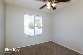 Phoenix house for rent - the living room has a ceiling fan and a large window