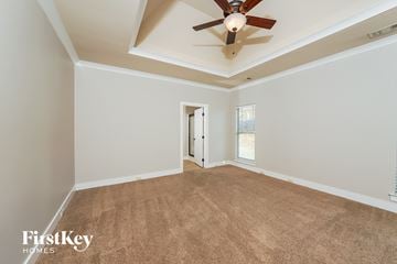 Calera house for rent - a living room with a ceiling fan and a carpet