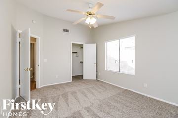 Glendale house for rent - a living room with carpet and a ceiling fan