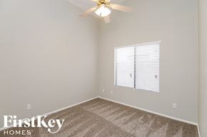 Glendale house for rent - a bedroom with a carpeted floor and a ceiling fan