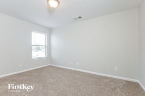 Calera house for rent - a bedroom with white walls and carpet and a window