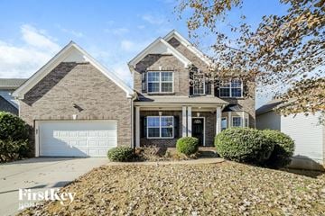 Villa Rica house for rent - a large brick house with a white garage door