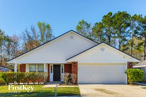 Middleburg house for rent - A white house with a garage door and a sign that says "FirstKey Homes".