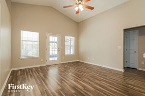 Middleburg house for rent - A spacious room with wooden floors and a ceiling fan.