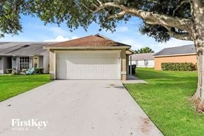 Lakeland house for rent - a white driveway with a white garage door in front of a house
