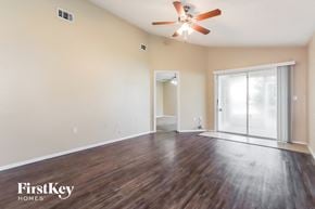 Lakeland house for rent - an empty living room with hardwood flooring and a ceiling fan