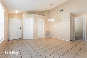 Lakeland house for rent - a spacious living room with a tiled floor and two closets