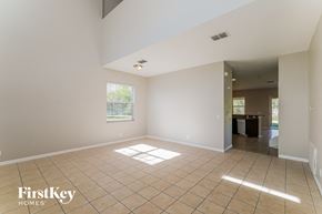 Tampa house for rent - an empty living room with tile flooring and a window