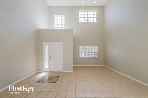 Tampa house for rent - an empty living room with a white door and windows