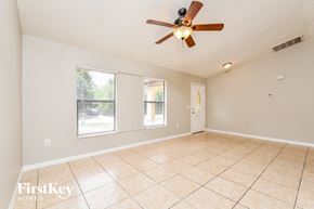 Port Charlotte house for rent - A spacious room with a ceiling fan and tiled flooring.