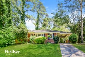 Decatur house for rent - a small brick house with a lawn and trees