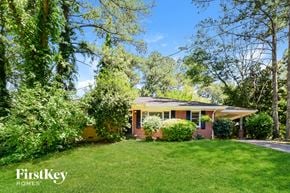 Decatur house for rent - a small brick house with a lawn and trees