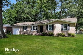 Charleston house for rent - A house with a white garage door and a brick exterior.