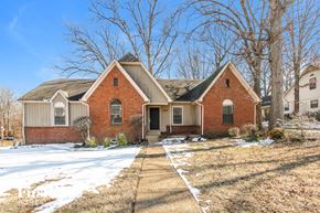 Cordova house for rent - A red brick house with a snow-covered ground in front.