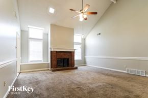 Cordova house for rent - A room with a fireplace and a ceiling fan.